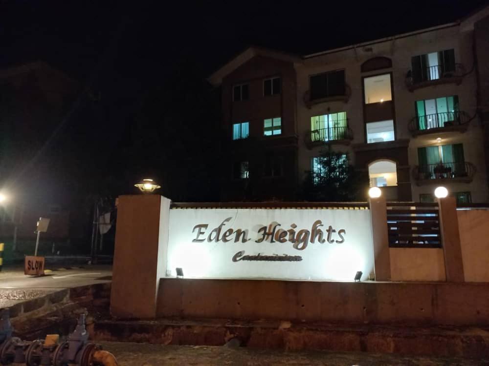 a sign in front of a building at night at Eden Penthouse Airport Access By Natol Homestay- Kuching Home in Kuching