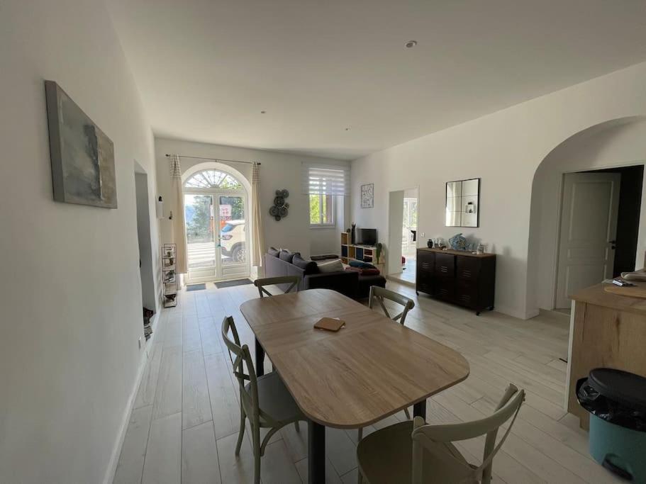 un salon avec une table et des chaises en bois dans l'établissement Quartier San Damianu - Sartène, à Sartène