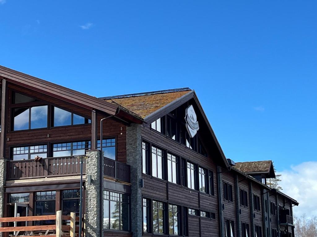 a large wooden building with a balcony on it at Mountain Lodge in Stöten