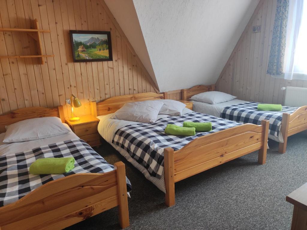a bedroom with two beds in a attic at U Wajdy in Małe Ciche