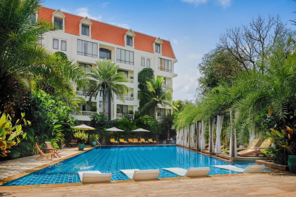 a swimming pool in front of a hotel at Palace Gate Hotel & Resort By EHM in Phnom Penh