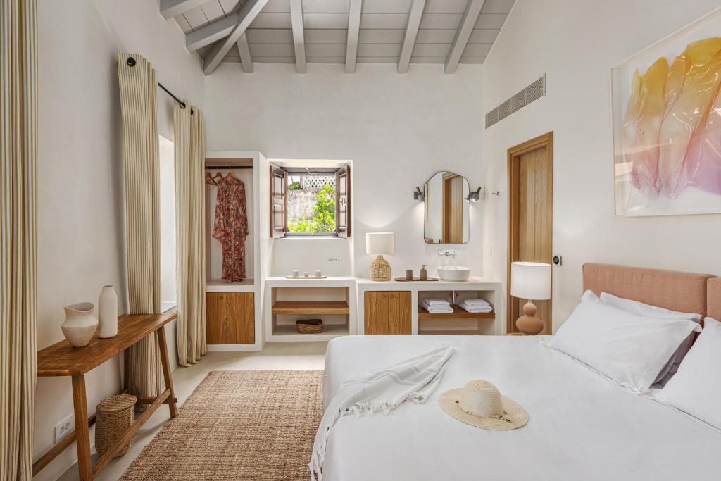 a bedroom with a bed and a bathroom with a sink at Teresa Spetses in Spetses
