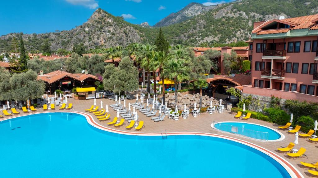 an image of a resort with a pool and chairs at Sundia By Liberty Suncity in Oludeniz