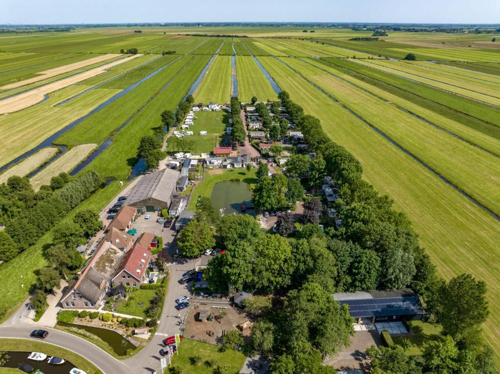 an aerial view of a park next to a field at Ben's Cabine in Bodegraven