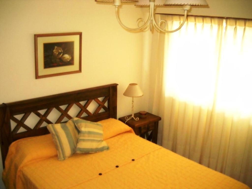 1 dormitorio con cama, lámpara y ventana en Apartamento Del Mar en Mar del Plata