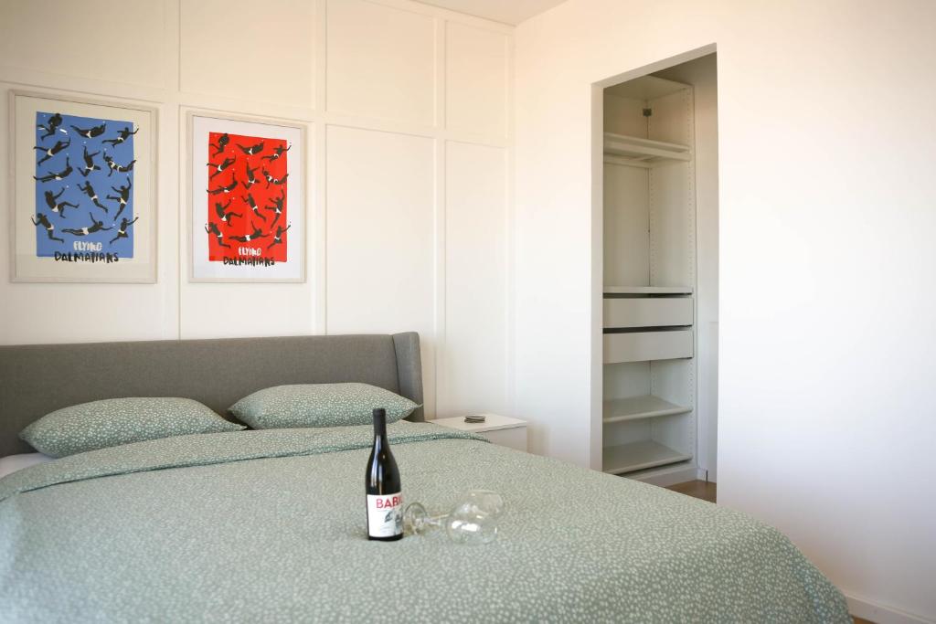 a bottle of wine sitting on top of a bed at Kiki's Sea View Studio's in Split