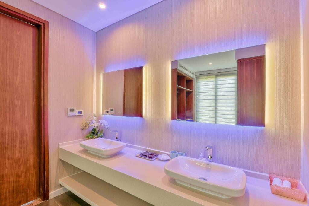 a bathroom with two sinks and a large mirror at Diamond Beach Villa Da Nang in Danang