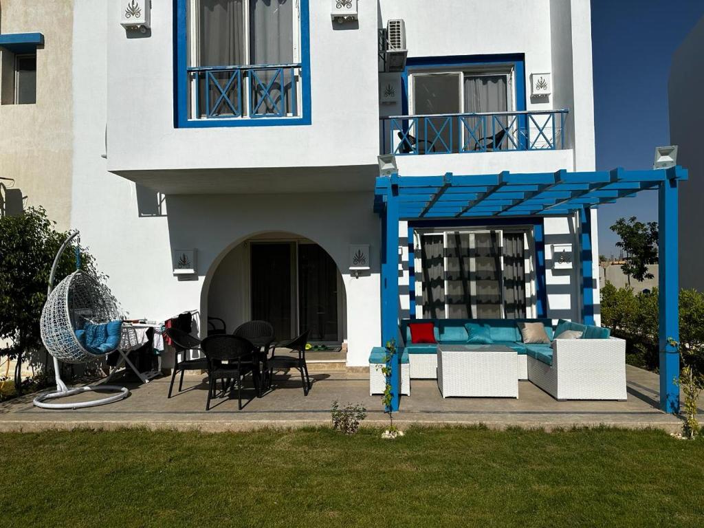a house with a bed and a table and chairs at Twin House 4Bedrooms in mountain view Ras Elhkima in Zāwiyat al ‘Awwāmah