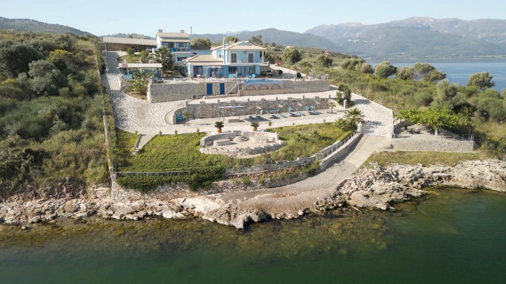 an aerial view of a house on a island in the water at Iris Villas in Spárton