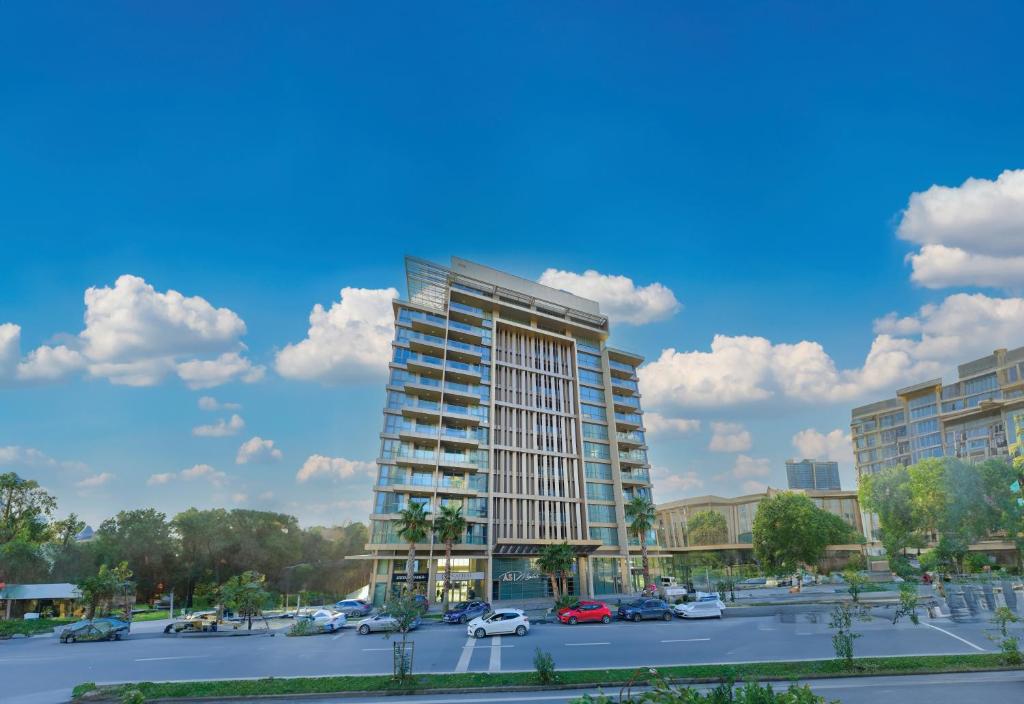 a rendering of a tall building in a parking lot at AS Maslak by NewInn in Istanbul