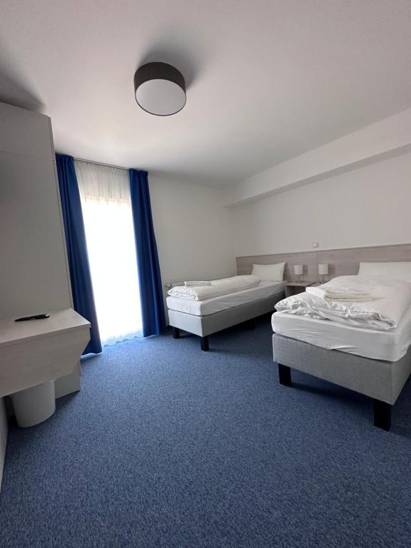 a hotel room with two beds and a window at Marina Park Eberswalde in Eberswalde