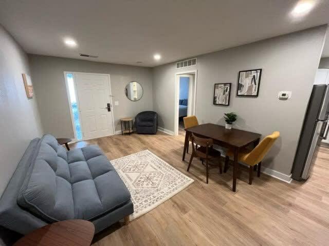 a living room with a couch and a table at Steps to Aksarben Village, Walk to UNO in Omaha