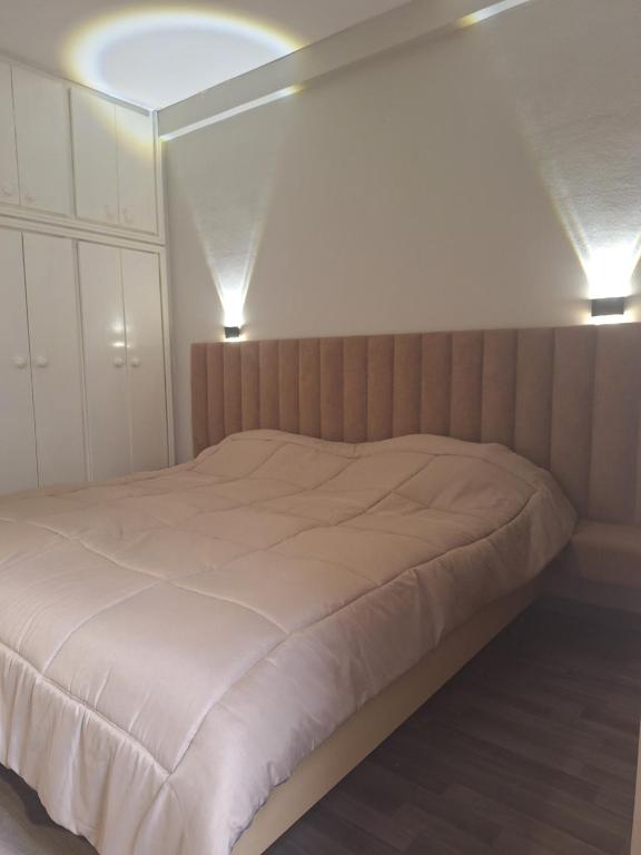 Un dormitorio con una cama con dos luces. en Hotel el Fawz en Monastir
