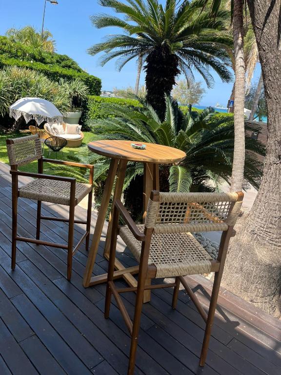 a wooden table and two chairs on a deck at Villa Olimpia in Mondello