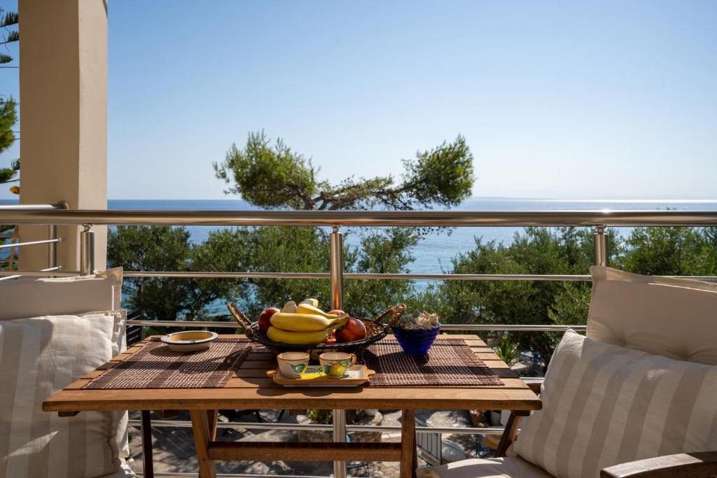 a table with a bowl of fruit on a balcony at SkyBlue Horizon Studio 3 in Tsilivi