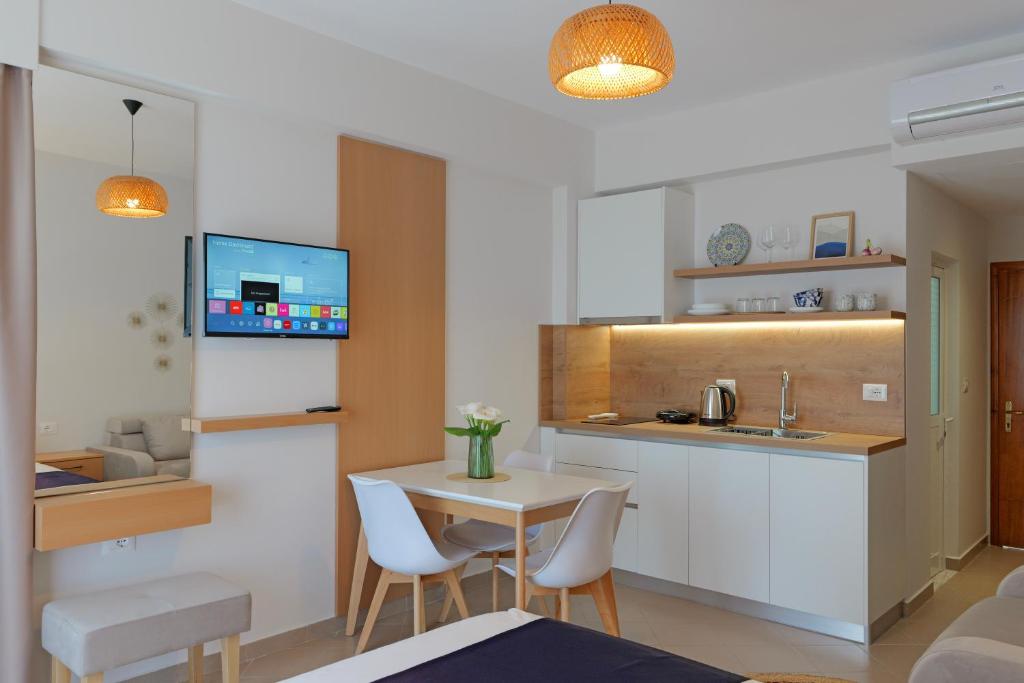 a kitchen with a table and a small table and chairs at Villa Pargua in Borsh