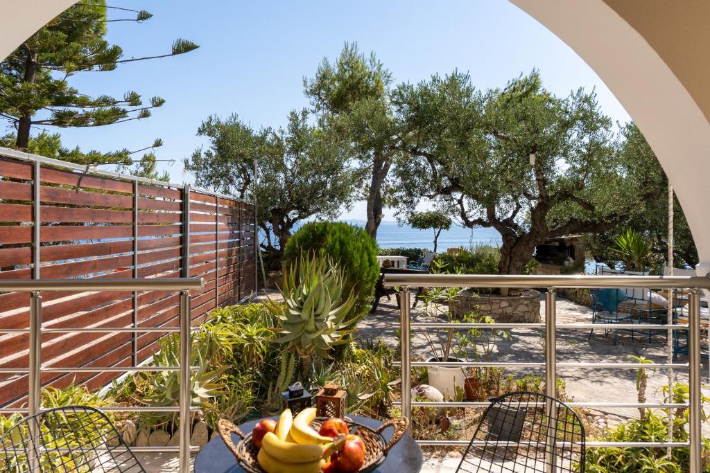 a table with a bowl of fruit on a balcony at SkyBlue Horizon Studio 2 in Tsilivi