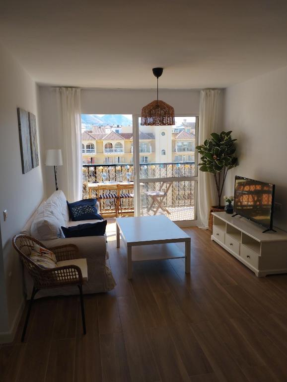 a living room with a couch and a coffee table at Apartamento Fuengirola Costa in Fuengirola
