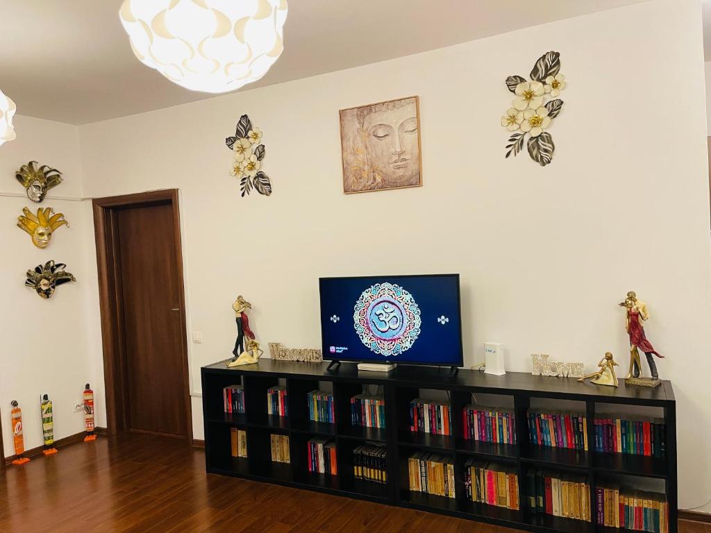 a living room with a book shelf with books at A.U.M House in Bucharest
