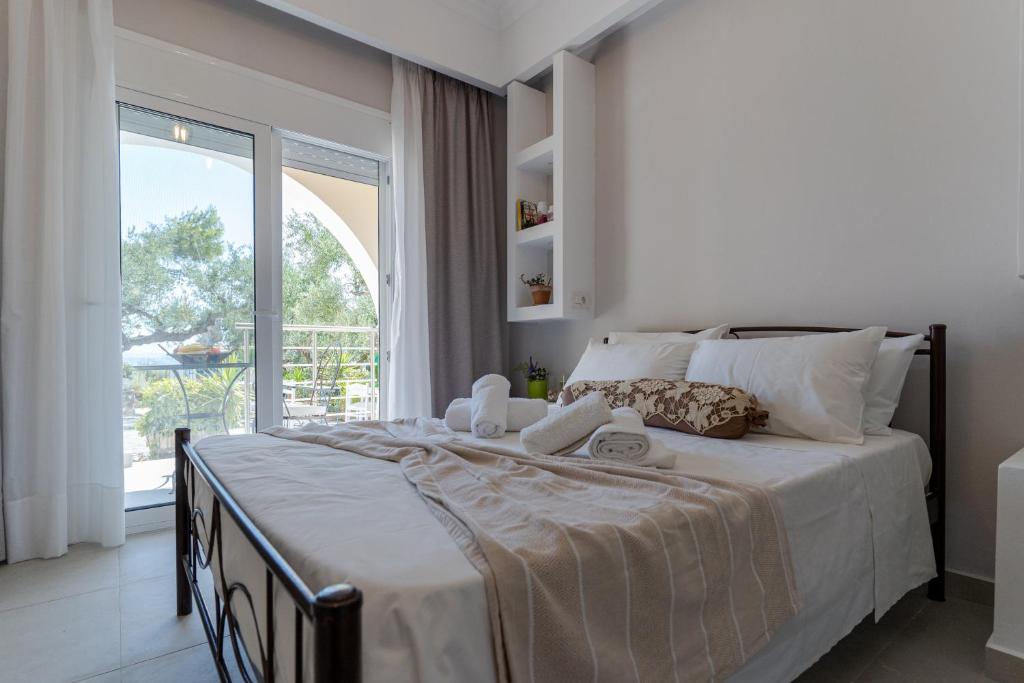 a bedroom with a large bed and a large window at SkyBlue Horizon Studio 1 in Tsilivi