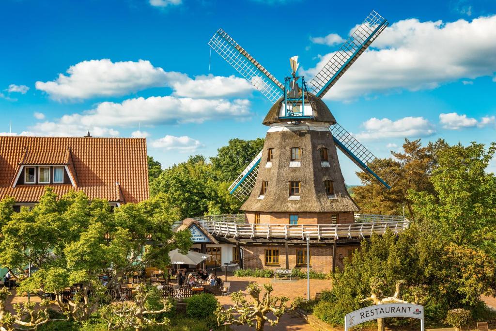 a windmill in front of a building at Landhotel Lewitz Mühle in Banzkow
