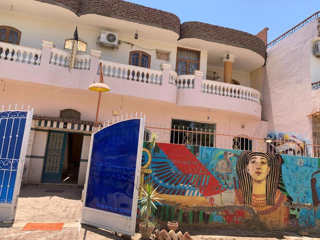 a building with a mural on the side of it at Villa Elhag Nile View in Luxor