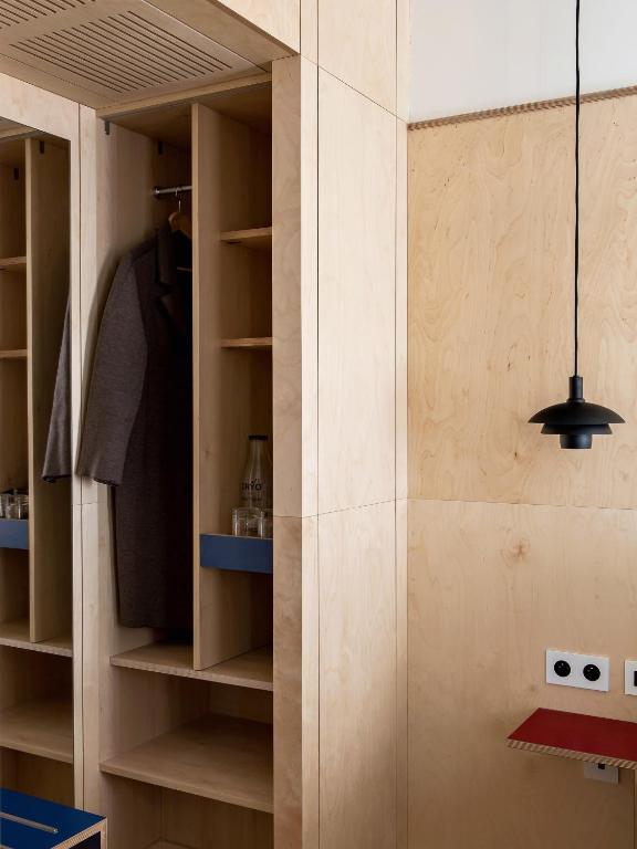 a room with a closet with wooden shelves at New Hotel Opéra in Paris