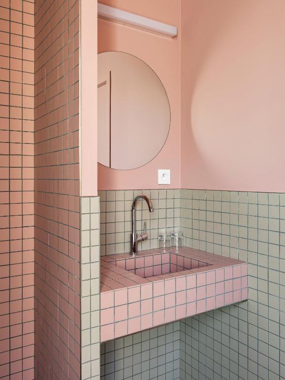 a bathroom with a sink and a mirror at New Hotel Opéra in Paris