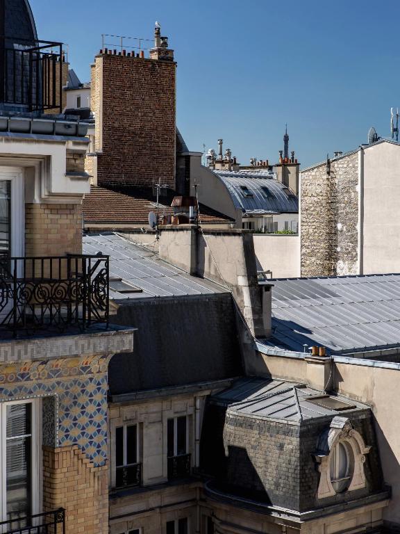 a view of roofs of buildings in a city at New Hotel Opéra in Paris