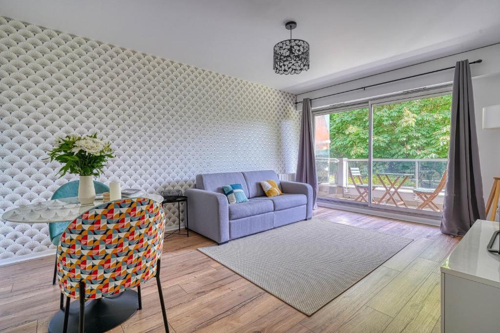 un salon avec un canapé et une table dans l'établissement Le Métropolitain - Proche de Paris - 338B, à Nogent-sur-Marne