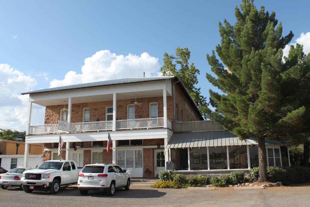 a building with cars parked in front of it at The Hotel Limpia in Fort Davis