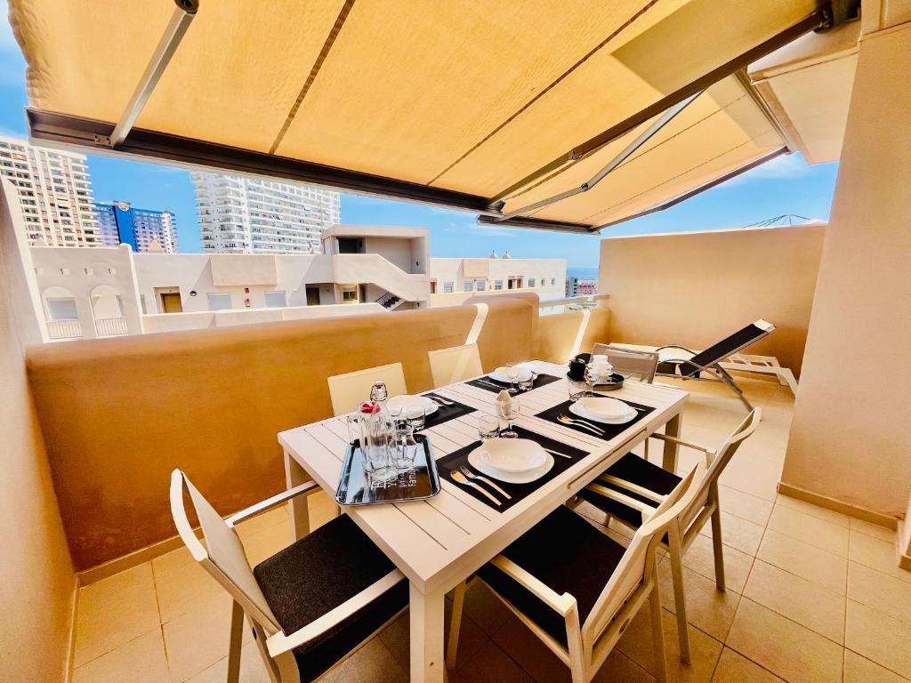 a dining room with a table and chairs on a balcony at El Horno in Adeje