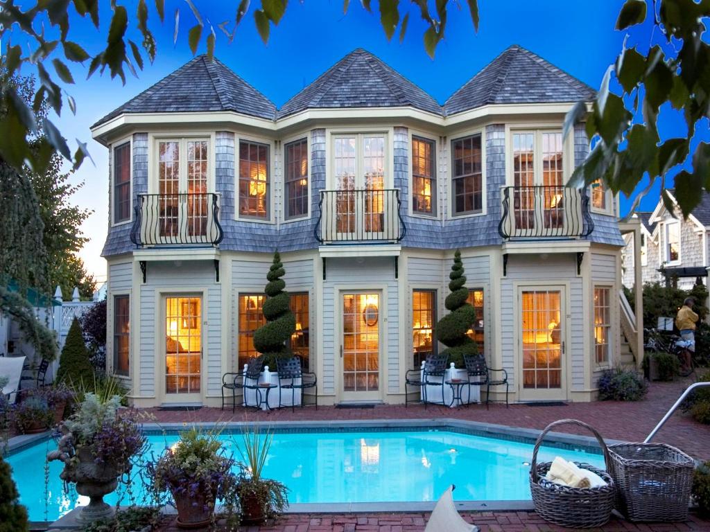 a house with a pool in front of it at Brass Key Guesthouse Adults Only in Provincetown