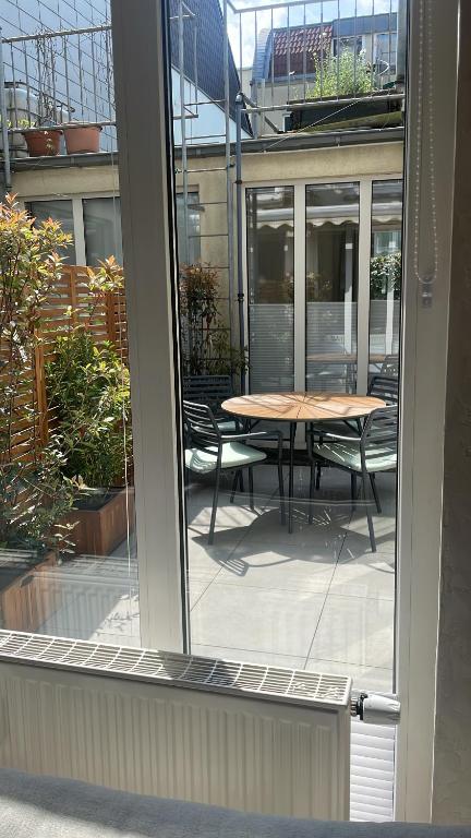 an open window with a table and chairs outside at Atrium Apartments Aachen in Aachen