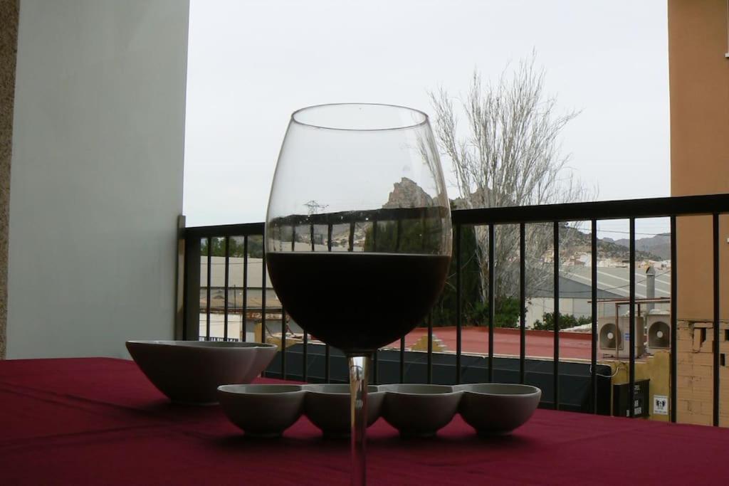 a glass of wine sitting on top of a table at Apartamento en centro de Archena in Murcia