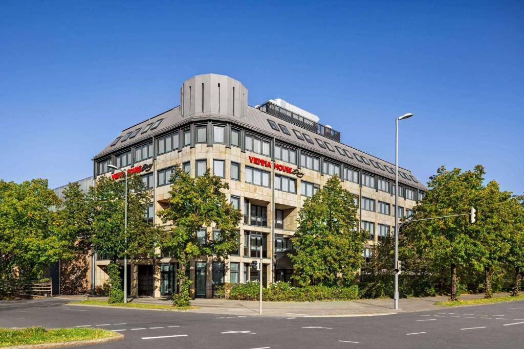 a large building on the corner of a street at Vienna House Easy by Wyndham München in Munich