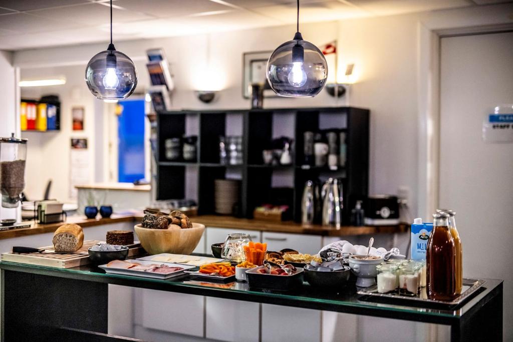 a counter with food on it in a kitchen at HOTEL SØMA Ilulissat in Ilulissat
