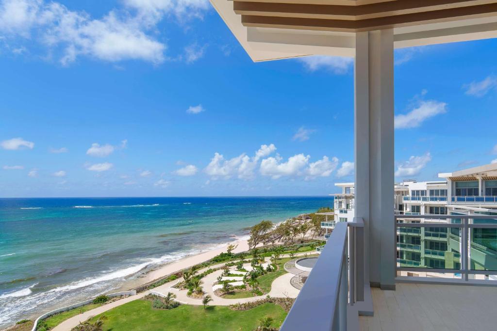 a view of the ocean from the balcony of a condo at Wyndham Grand Barbados Sam Lords Castle All Inclusive Resort in Saint Philip