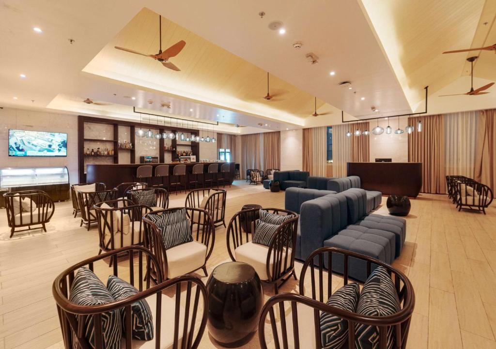 a large waiting room with chairs and a piano at Wyndham Grand Barbados Sam Lords Castle All Inclusive Resort in Saint Philip