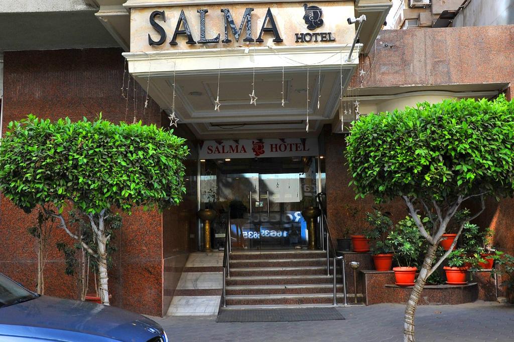 a sigma hotel with stairs leading into a building at Salma Hotel Cairo in Cairo