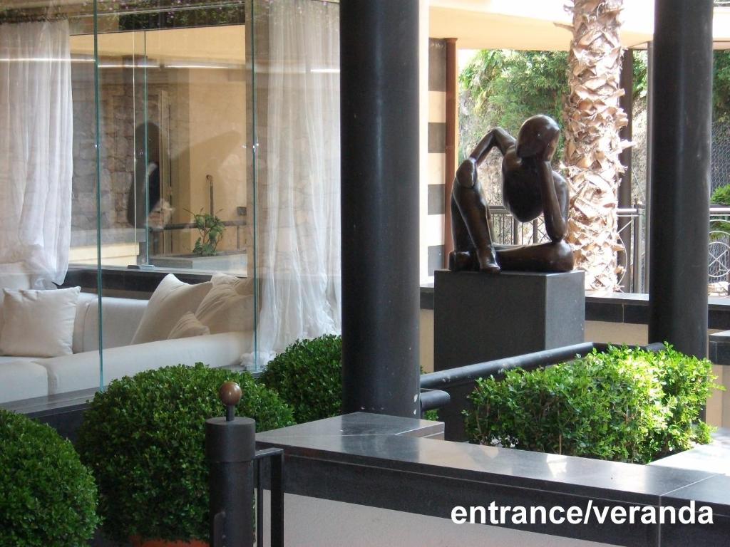 a statue of a woman sitting on a table in a building at casagratia in Taormina