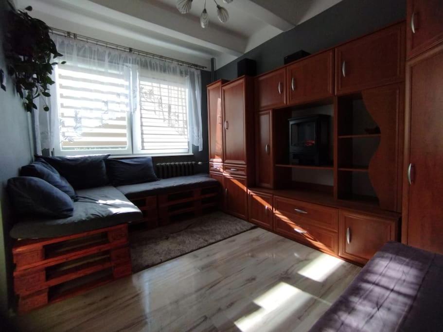 a living room with a couch and a tv at Apartament nadmorski w Gdańsku in Gdańsk