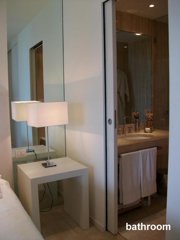 a bathroom with a lamp on a table and a sink at casagratia in Taormina