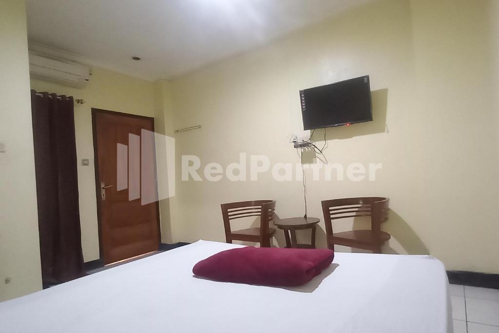 Postelja oz. postelje v sobi nastanitve Hotel Palem 2 Syariah Malang Redpartner