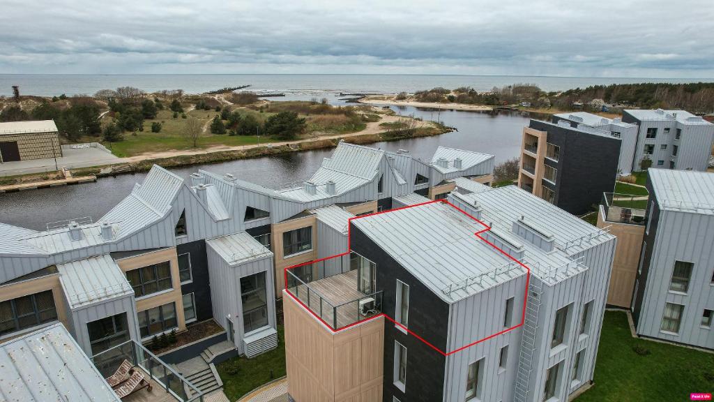 an aerial view of buildings and a river at SeaView, 5*Appartment,RoofTopTerrace, WalkToBeach in Šventoji