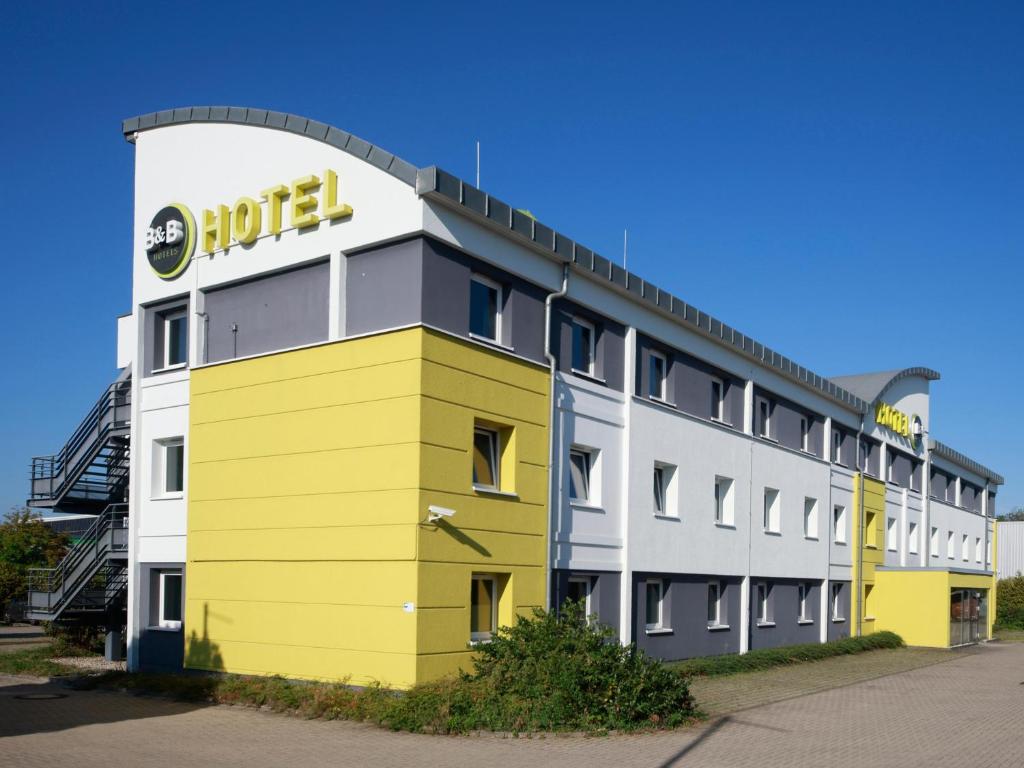 un edificio con un cartel de auds en el costado en B&B Hotel Leipzig-Nord, en Leipzig