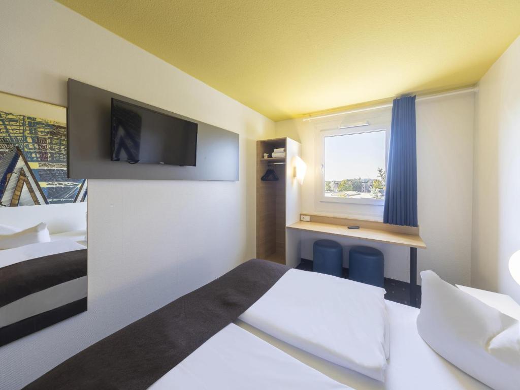Postel nebo postele na pokoji v ubytování B&B Hotel Leipzig-Nord