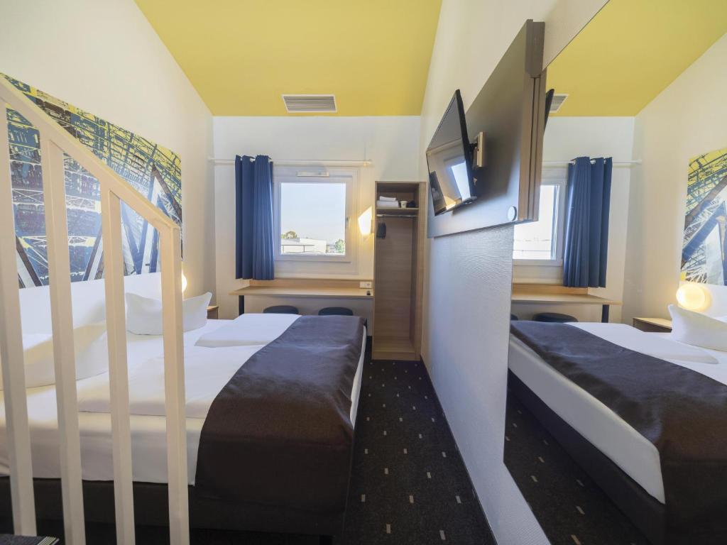 Postel nebo postele na pokoji v ubytování B&B Hotel Leipzig-Nord