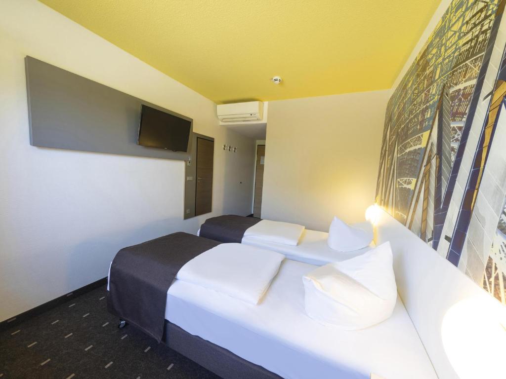 Postel nebo postele na pokoji v ubytování B&B Hotel Leipzig-Nord