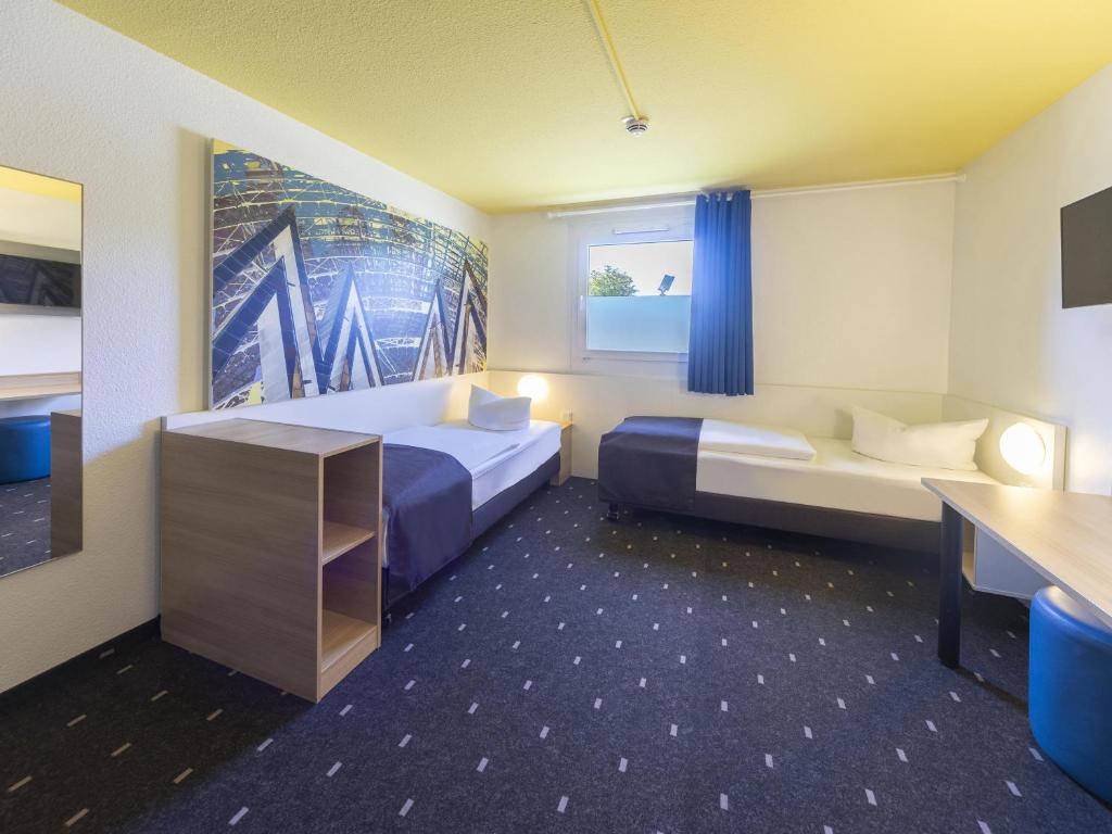 Postel nebo postele na pokoji v ubytování B&B Hotel Leipzig-Nord